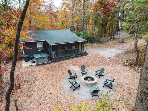 Hocking Hollows cabin with hot tub and fire pit surrounded by autumn woods