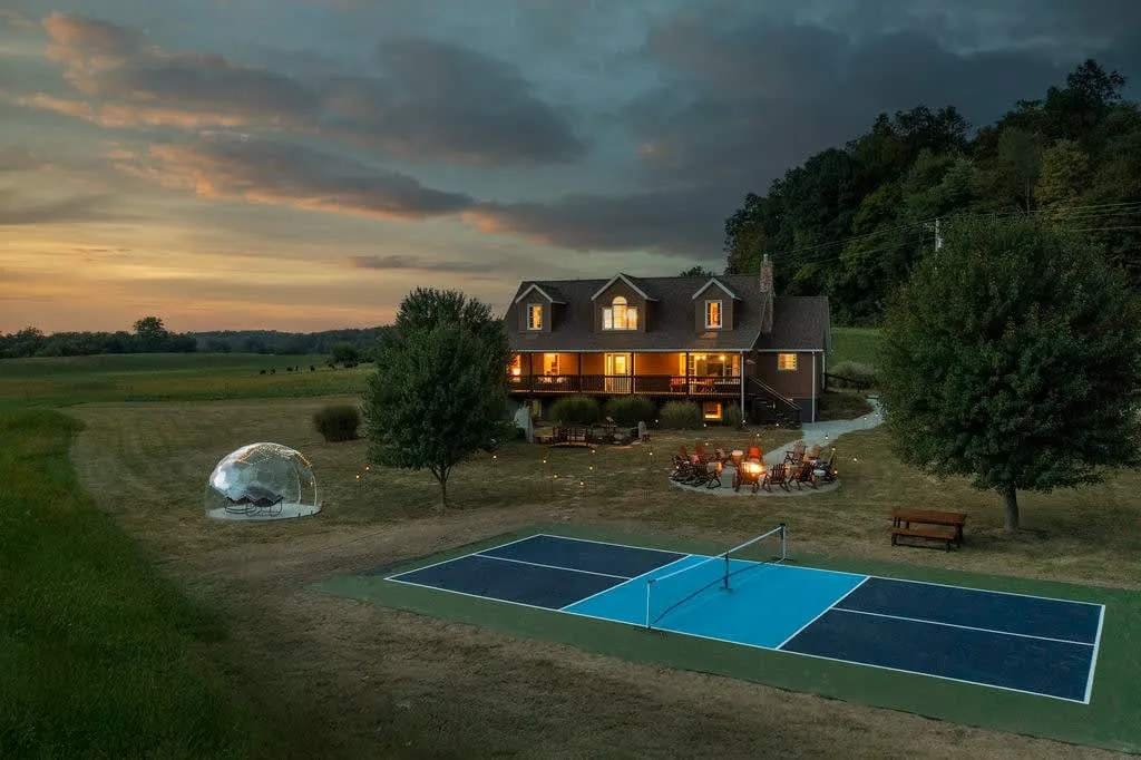 Stoneveil Retreat at dusk with pickleball court, fire pit and stargazing dome in Hocking Hills